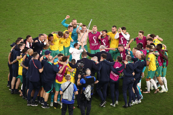 Graham Arnold and his team celebrate the historic win over Denmark.