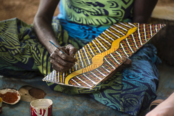 An artist at work at Tiwi Design.