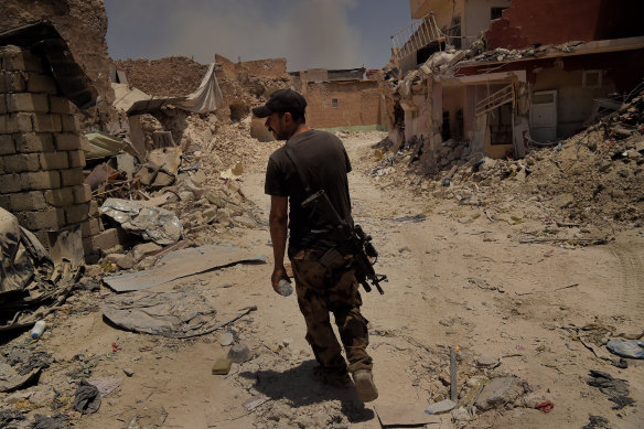 A soldier from the Iraq Special Forces’ Golden Division walks through the streets during an  offensive to retake West Mosul in 2017.