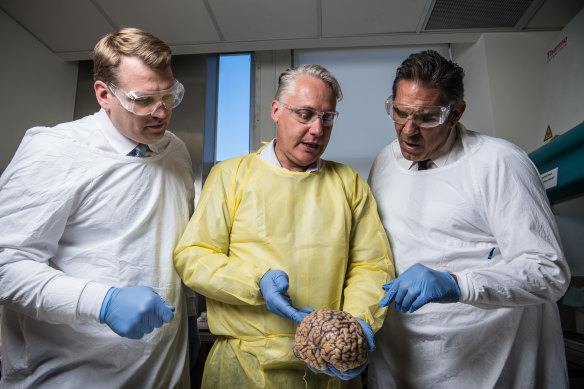 Concussion expert Dr Chris Nowinski, left, pictured with colleagues in 2018. 