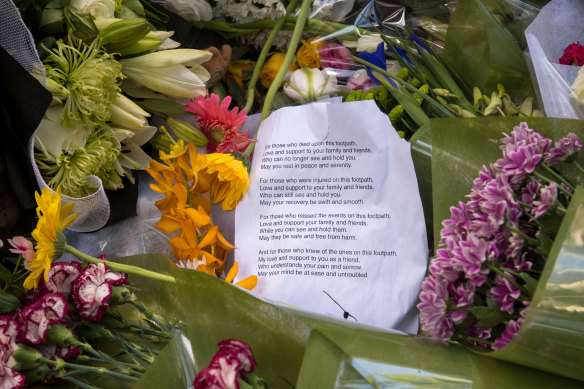 A message left for the victims among the flowers.