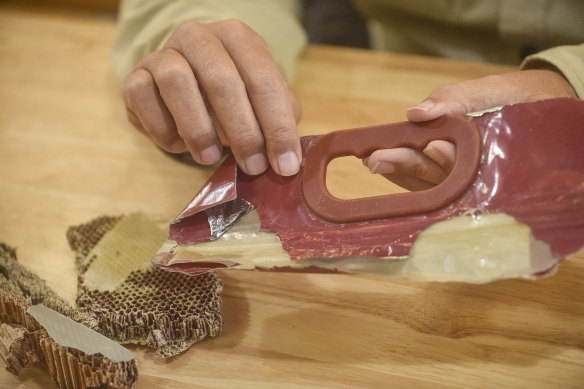 A suspected piece of cabin wall with a honeycomb-pattern interior and the remnants of a bag the same colour as a Kuala Lumpur airport duty-free bag.