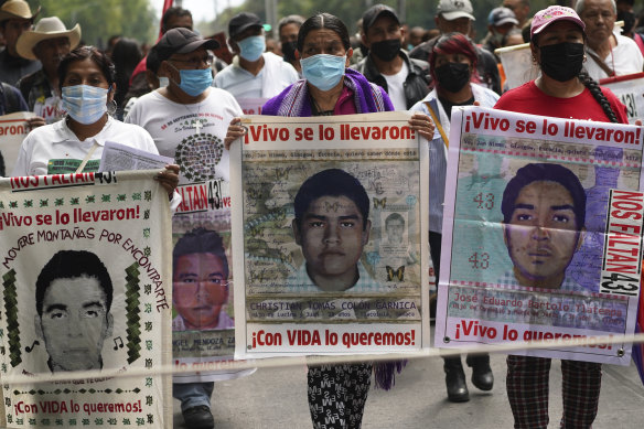 Family members and friends march in Mexico City on August 26 seeking justice for the missing 43 Ayotzinapa students.