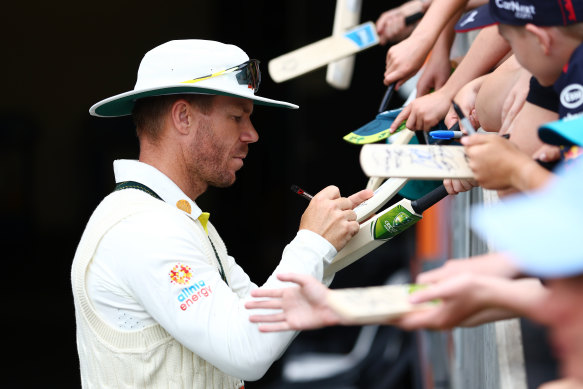 David Warner signs autographs for eager fans in Adelaide.