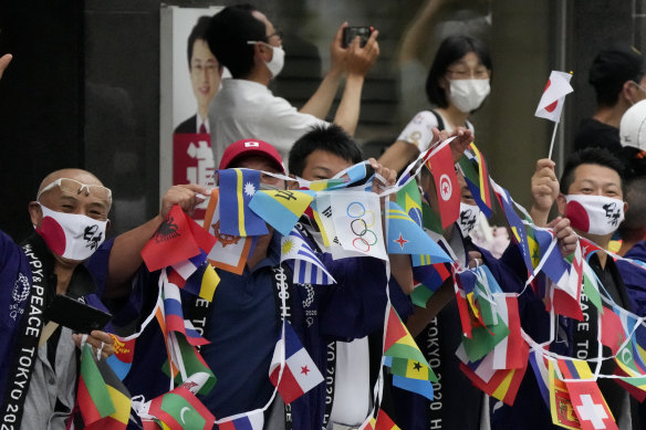 Spectators join the fun at the Tokyo Olympics men’s marathon on Sunday.