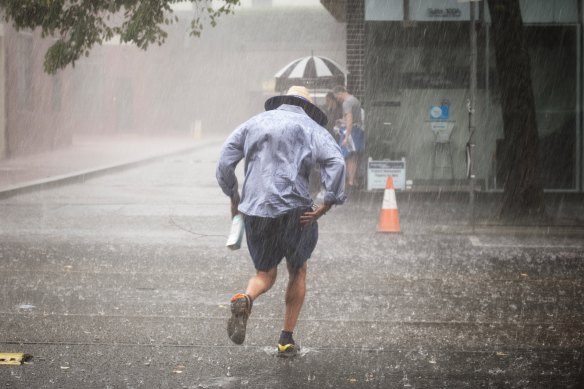 A person seeks shelter from the storm in Carlton on Friday.