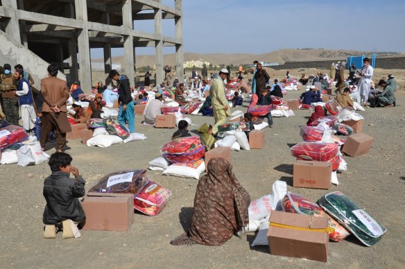 People receive relief supplies from aid agencies in Khost province, east Afghanistan, last November, ahead of winter.  