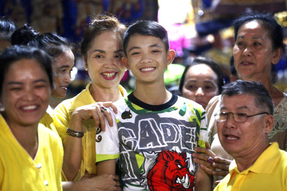 Duangpetch Promthep is greeted by relatives at his home in Mae Sai district, Chiang Rai province, northern Thailand after the rescue in 2018. The soccer team captain died on Wednesday in England.