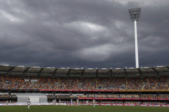 Players watch as rain clouds gather during play on day two of the fourth Test.