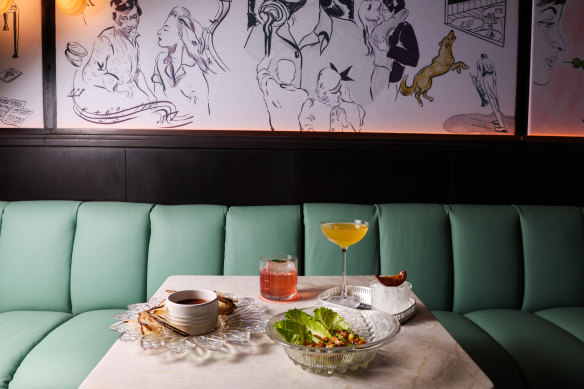 A mint green leather banquette wraps around the main bar.