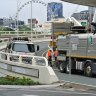 Garden debris from the Queen’s Wharf precinct washed into drains along the Margaret Street off-ramp, forcing road closures.