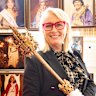 Former Melbourne lord mayor Sally Capp with a Moomba sceptre and portraits of Moomba monarchs.