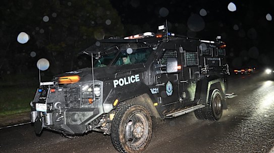Special operations police leaving the property at Porepunkah.