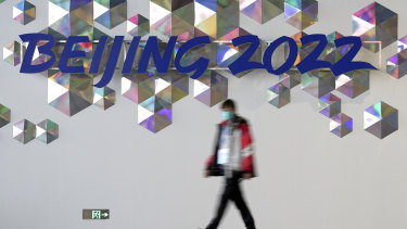 A person walks past a Beijing 2022 sign inside the main media center at the 2022 Winter Olympics, Saturday, Jan. 22, 2022, in Beijing. (AP Photo/David J. Phillip)