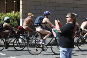What was that? An onlooker snaps participants in the World Naked Bike Ride in inner Melbourne on Sunday.