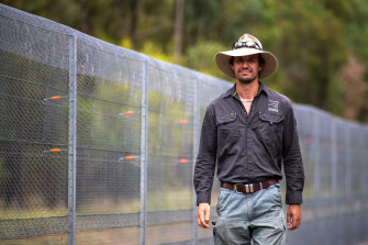 Wayne Sparrow, AWC Pilliga operations manager, alongside the wildlife sanctuary’s fence. He estimates that he and his team have dedicated almost 4500 working hours to the hunt for Rambo. 