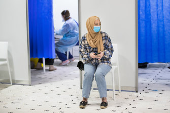 A woman waits to get her COVID-19 vaccine at a pop-up vaccination centre at the mosque on Blenheim Road, Newport.
