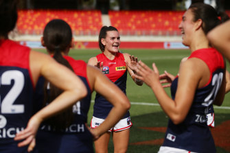 Lily Mithen and the Demons celebrate victory over GWS just before the season was called off in 2020.