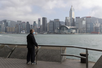 A man looks out on Hong Kong's Victoria Habour from the near-empty Tsim Sha Tsui Promenade, which is usually bustling with tourists.