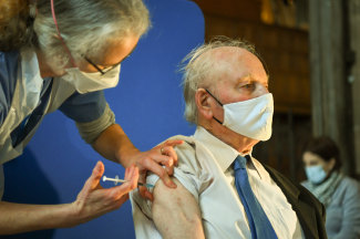 A man receives the Pfizer COVID-19 vaccine in England last month. Australia has orders for 20 million doses. 