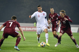 Poland's Robert Lewandowski (centre) in action against Latvia.