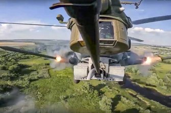 In this photo supplied by the Russian military, a Russian Mi-28 anti-armour attack helicopter fires rockets on a mission at an undisclosed location in Ukraine.