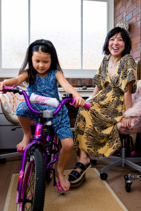 Eve Wong and her daughter Esther, 6, who has a new bike for Christmas bought secondhand from Marketplace. 