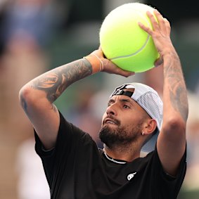 Kyrgios having fun at Kooyong shooting hoops with a giant tennis ball.