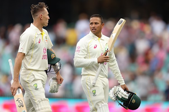 Marnus Labuschagne and Usman Khawaja leave the field due to bad light at the SCG.