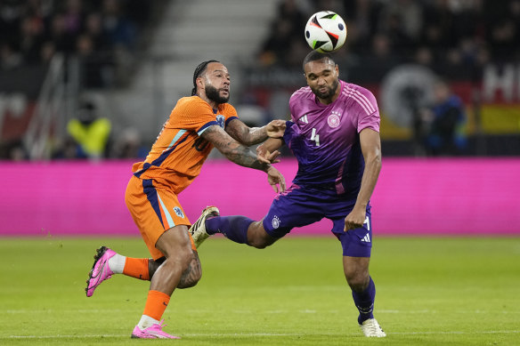 Germany’s Jonathan Tah (right) wears the No.4 jersey in a match against the Netherlands last week.