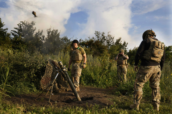 Ukrainian servicemen fire mortar towards Russian positions at the frontline near Bakhmut, 