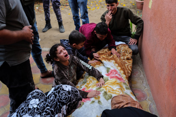 People mourn as they collect the bodies of Palestinians killed in Israeli raids in Khan Yunis, in Gaza’s south.