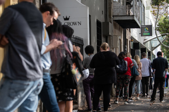 People queue for access to a Centrelink service centre in Sydney.