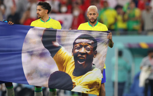 Brazil’s Neymar and Marquinhos hold a banner in support of Pele at the 2022 World Cup in Qatar.