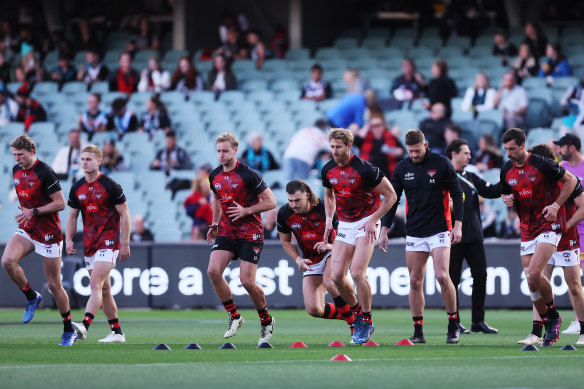 Essendon warms up.