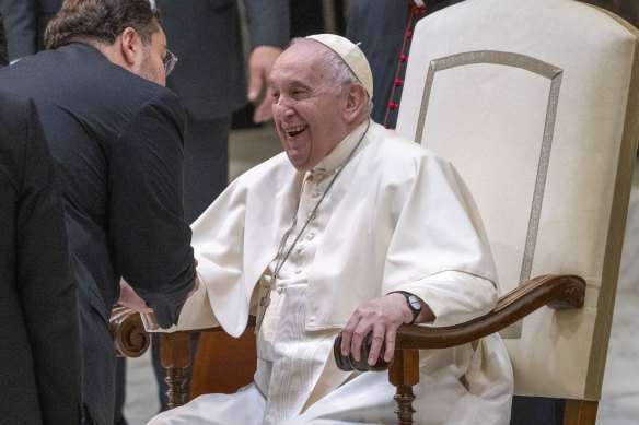 Pope Francis talks to a guest in the Paul VI Hall at The Vatican at the end of his weekly general audience, on Wednesday, December 14.