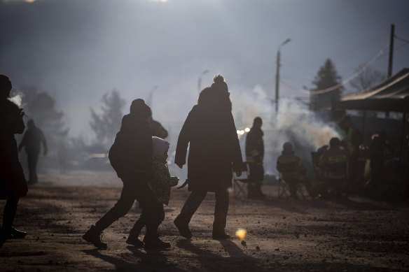 Ukrainian refugees wait for a train heading for Krakow at the border crossing in Medyka, Poland.