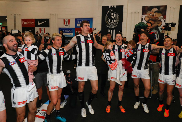 Collingwood players sing the team song after the heart-stopping win.