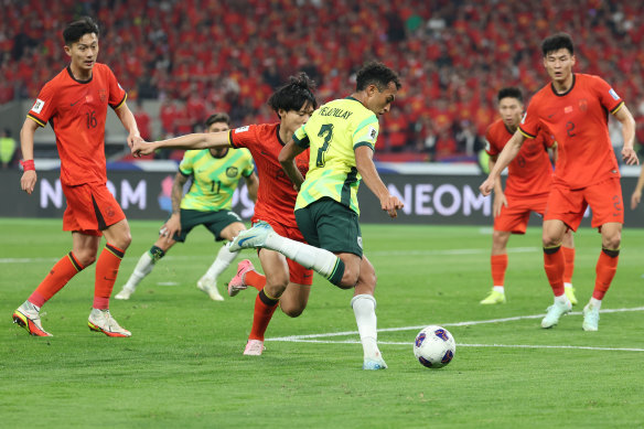 Nishan Velupillay controls the ball against China’s Wang Haijian.