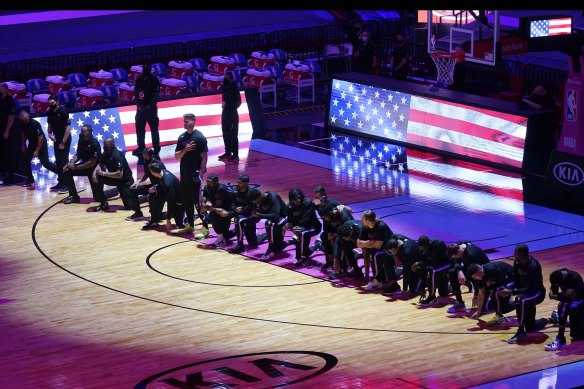 Boston players kneel in protest before their NBA match against Miami.