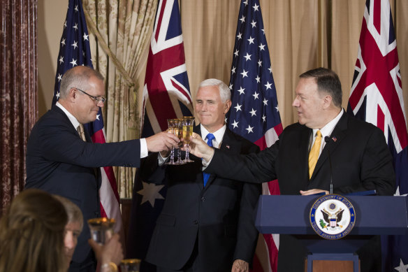 Then-PM Scott Morrison was toasted by then-vice president Mike Pence, centre, and then-secretary of state Mike Pompeo, right, in Washington in 2019.