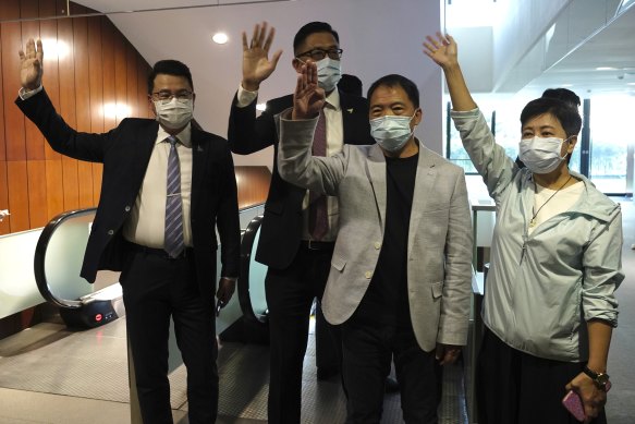 Pro-democracy legislators, from right, Wong Pik Wan, Wu Chi Wai, Lam Cheuk-ting, Yoon Siu Kin wave after handing their letters at the Legislative Council in Hong Kong. 