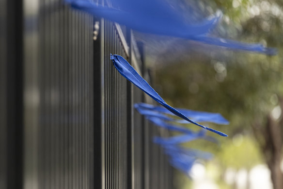 Blue ribbons have been tied to the fence at the academy. 