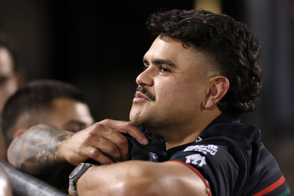 Latrell Mitchell watches from the sideline.