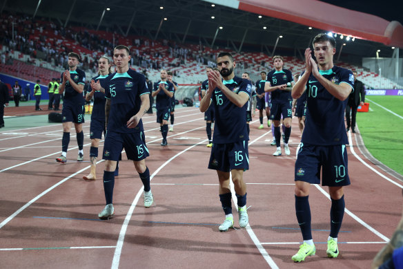 The Socceroos applaud the crowd at full-time.
