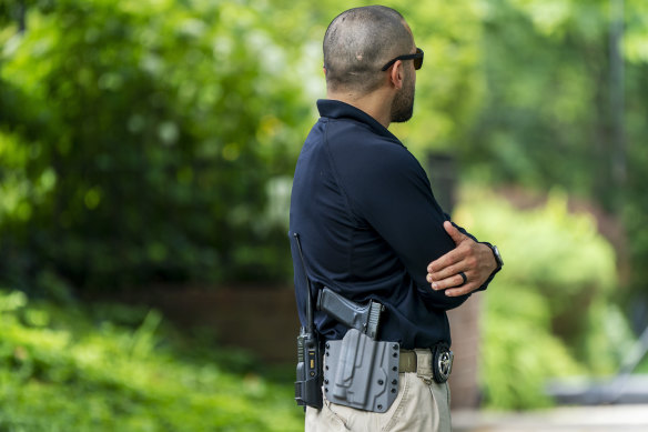 A US Marshal patrols outside the home of Supreme Court Justice Brett Kavanaugh.
