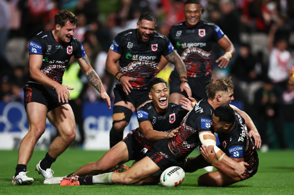 Mathew Feagai celebrates his late try with teammates.