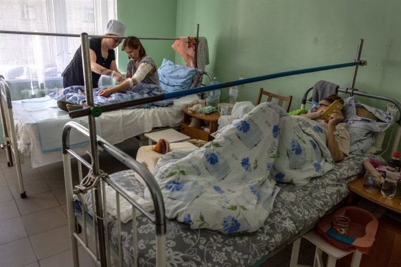 A nurse checks the wounds of Ponomareva Natalia Sergiivna three days after her family’s home was shelled by Russian forces in their frontline village of Vysokopilla in the Kherson region of southern Ukraine.
