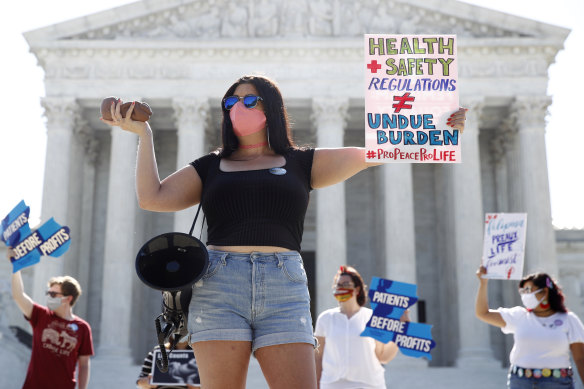 Anti-abortion protesters stand outside the US Supreme Court on Monday.