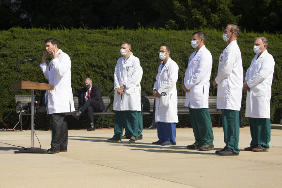 White House chief of staff Mark Meadows listens as doctors give a press conference on the condition of President Donald Trump outside Walter Reed National Military Medical Centre in Bethesda, Maryland, on Sunday.